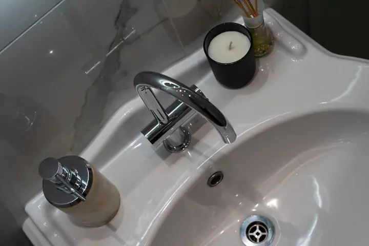 Looking down on a white basin and chrome mixer